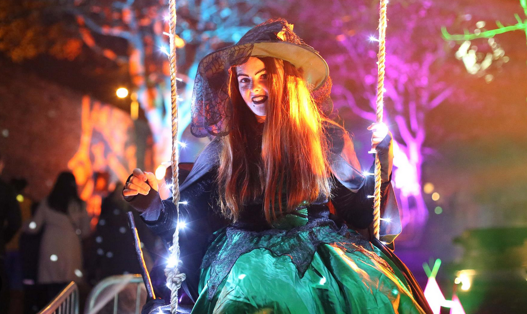 Witch on a swing at Derry Halloween Festival